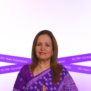 Professional woman in a purple saree with hands in a namaste gesture against a pink-purple background, conveying expertise and welcome stance.